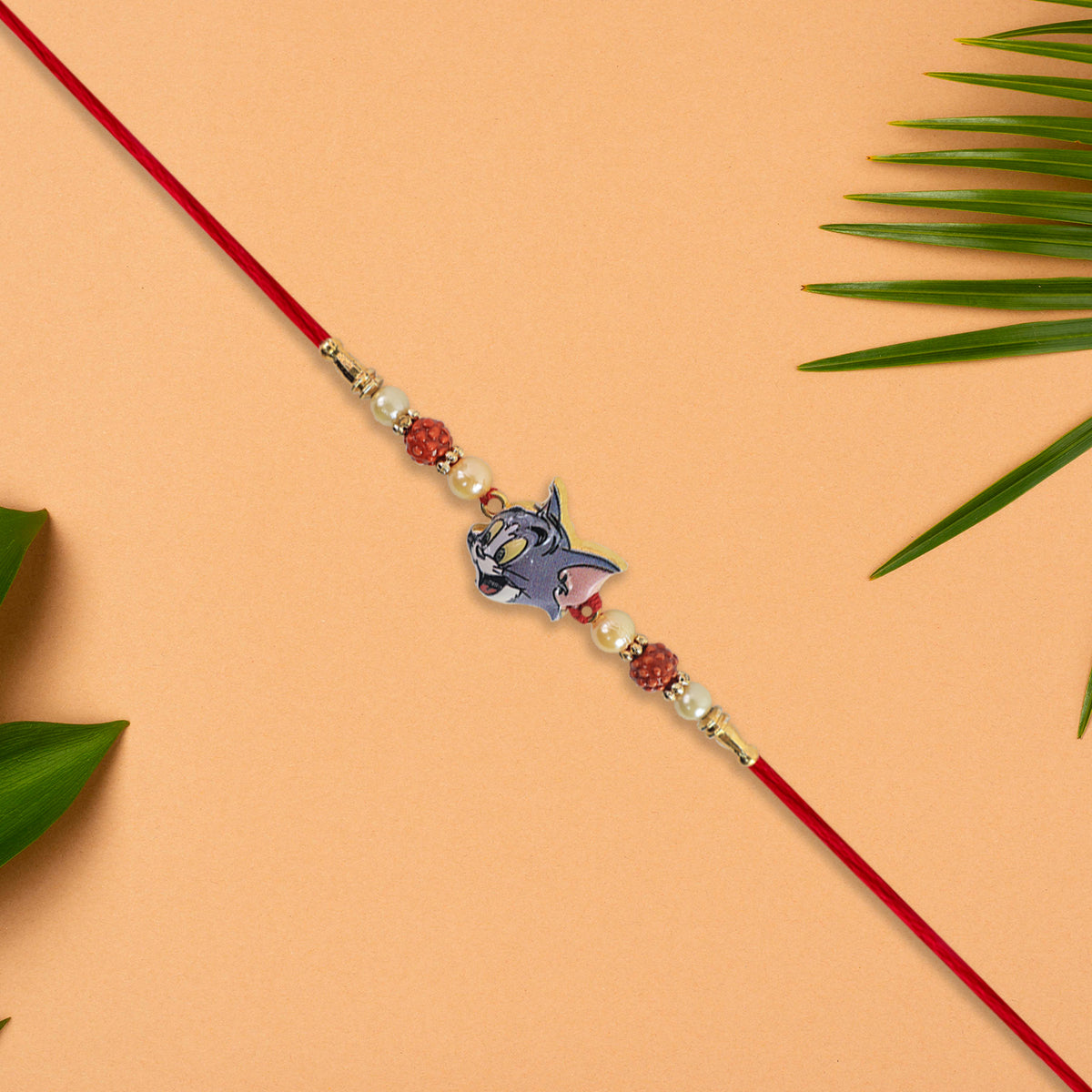 Cute Tom Character Rakhi With Rudraksha  Pearl Beads On Red Thread